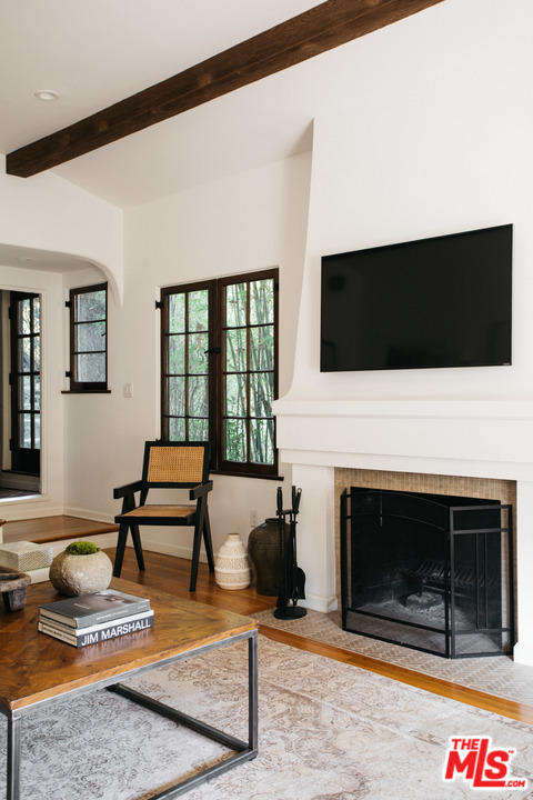 8515 Ridpath Drive Los Angeles, CA 90046 - Photo 6 of 20 a living room with furniture a flat screen tv and a fireplace