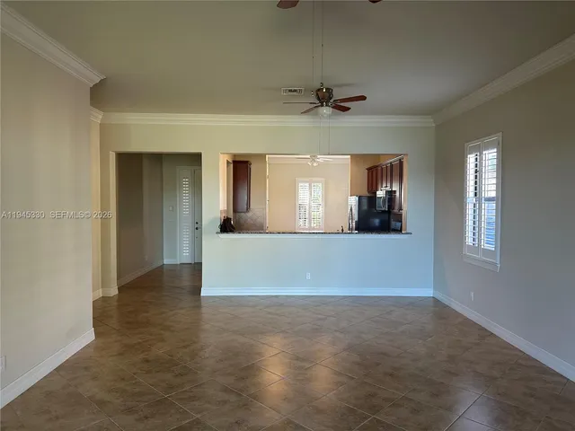 a view of livingroom and kitchen with hardwood floor and fan
