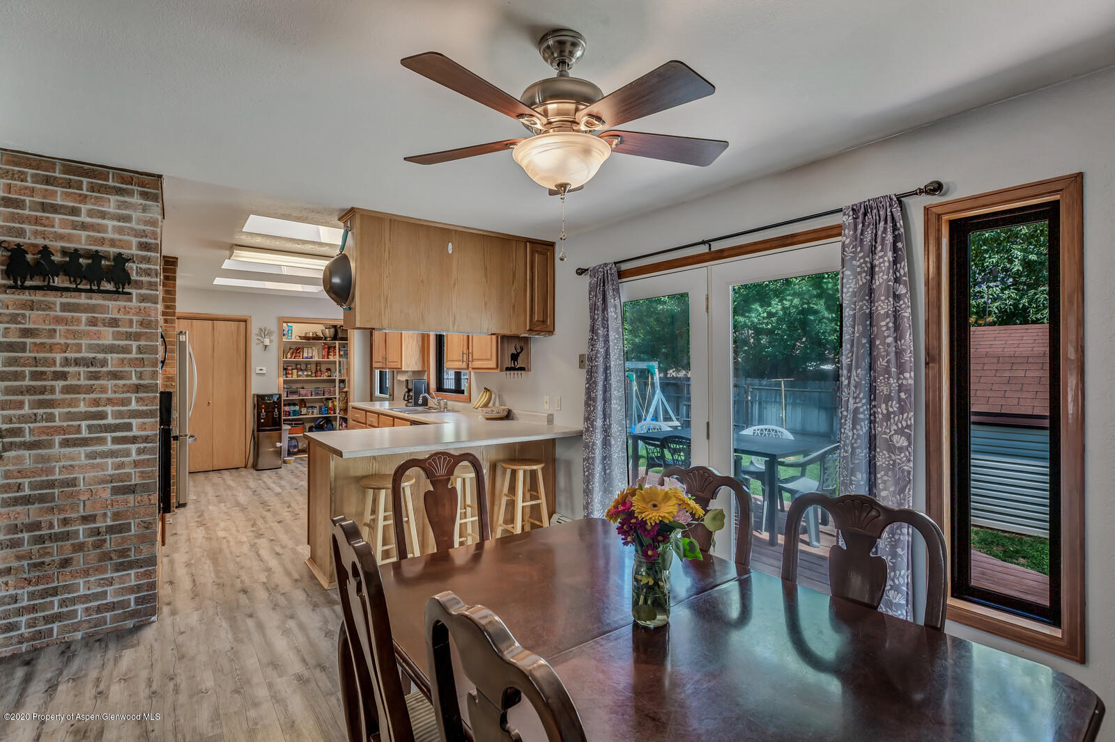 550 Aspen Avenue Rifle, CO 81650 - Photo 12 of 25 a dining room with furniture a chandelier and wooden floor