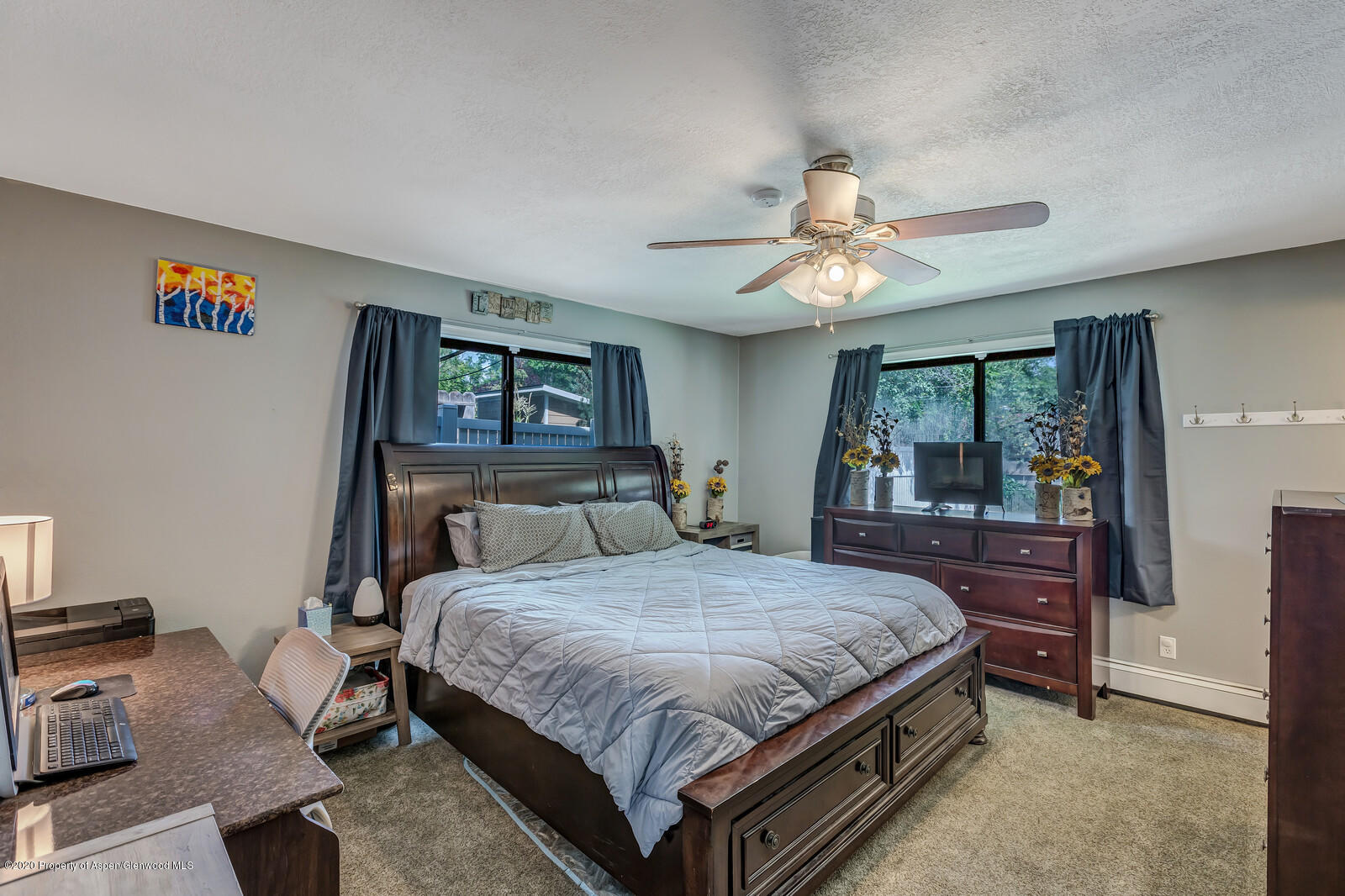 550 Aspen Avenue Rifle, CO 81650 - Photo 14 of 25 a bedroom with a bed and a chandelier