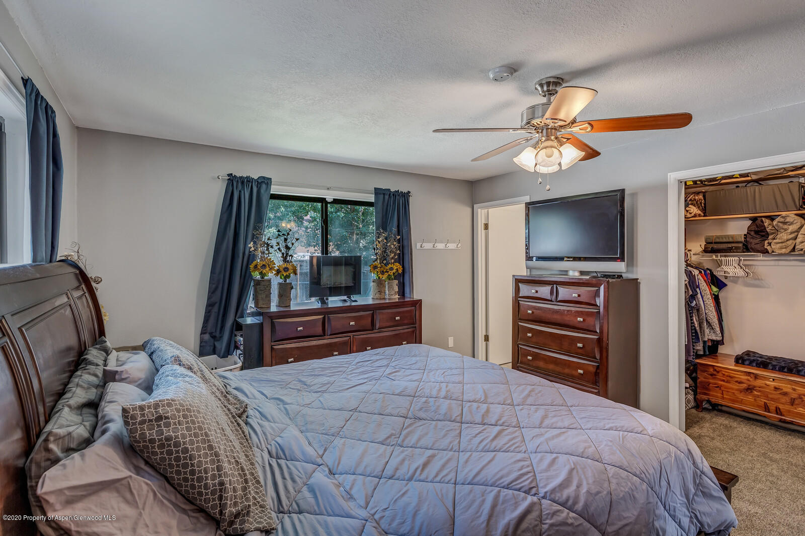 550 Aspen Avenue Rifle, CO 81650 - Photo 15 of 25 a bedroom with a bed and a flat screen tv