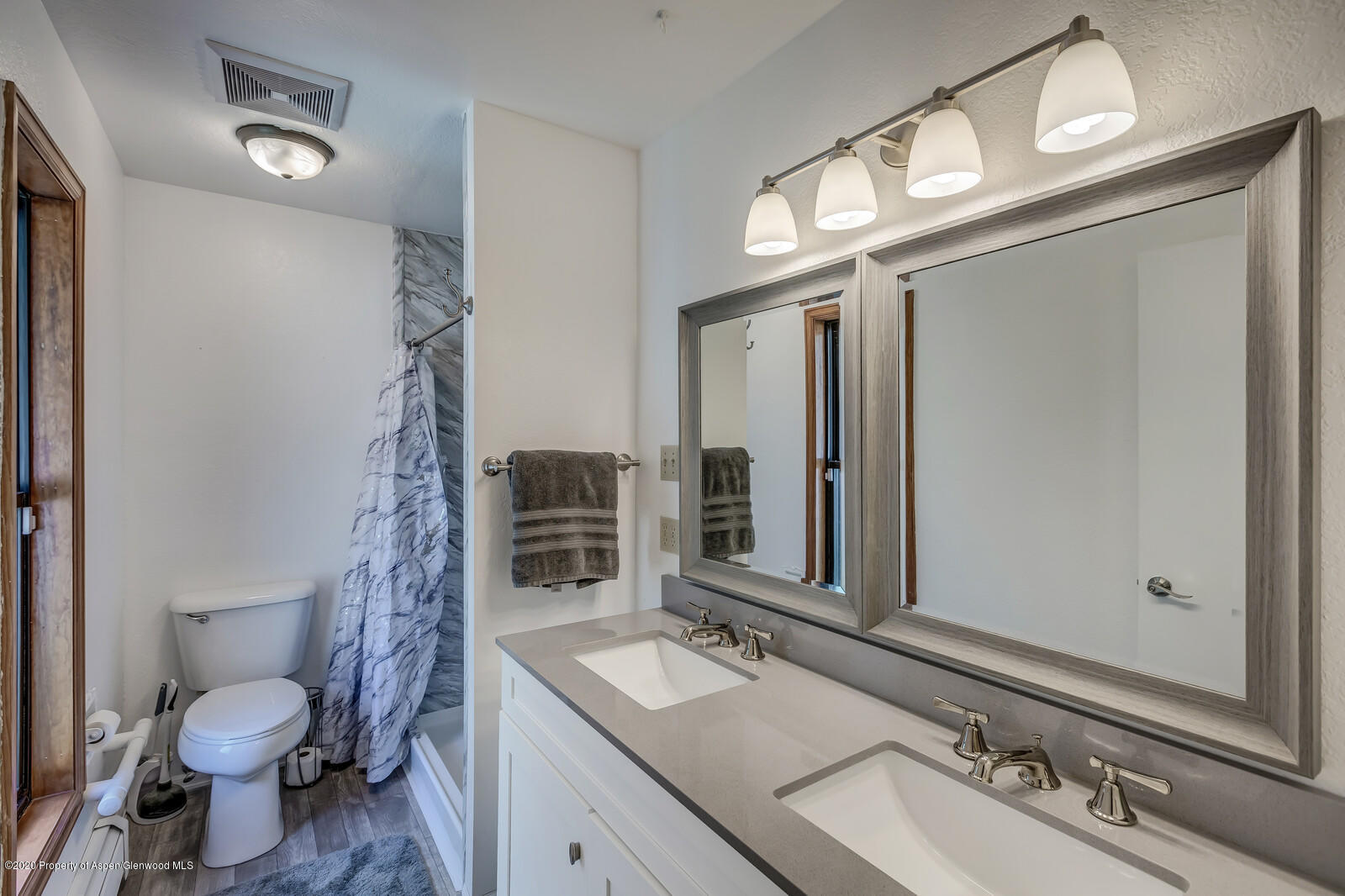 550 Aspen Avenue Rifle, CO 81650 - Photo 16 of 25 a bathroom with a sink vanity granite toilet and a mirror