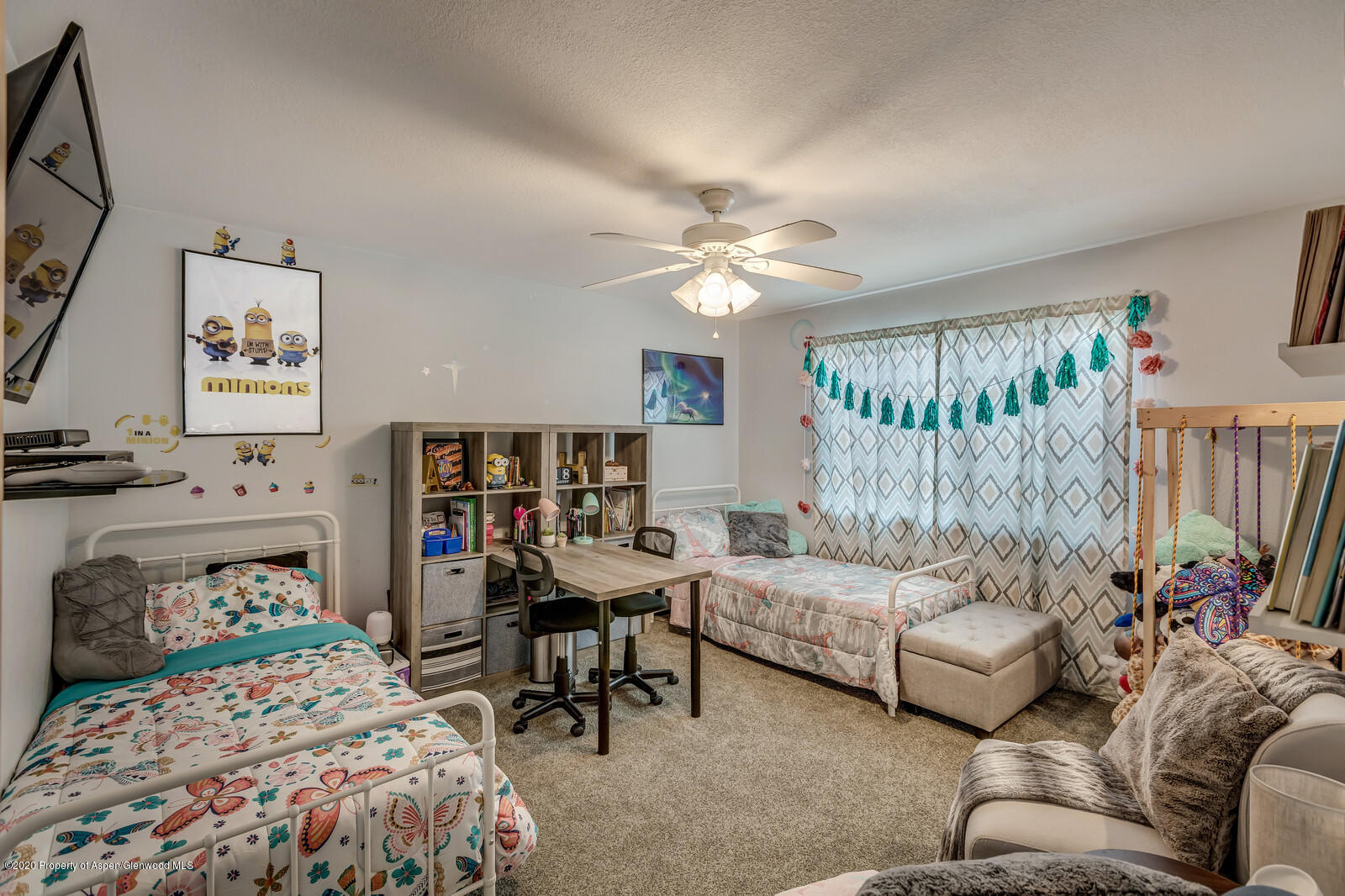 550 Aspen Avenue Rifle, CO 81650 - Photo 18 of 25 a bedroom with a bed a couch and a window