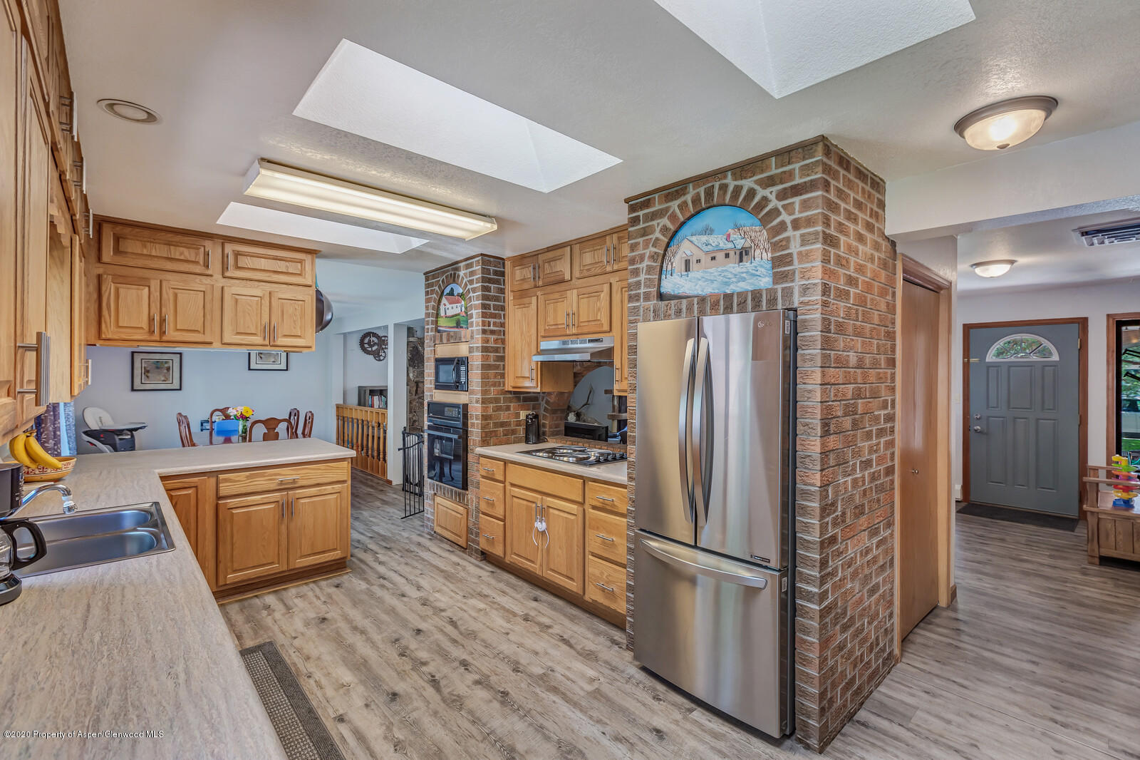 550 Aspen Avenue Rifle, CO 81650 - Photo 8 of 25 a kitchen with stainless steel appliances granite countertop a refrigerator a stove and a wooden floors