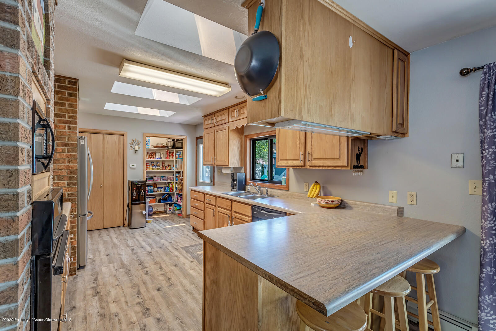 550 Aspen Avenue Rifle, CO 81650 - Photo 10 of 25 a kitchen with stainless steel appliances granite countertop a sink a stove and a wooden floors