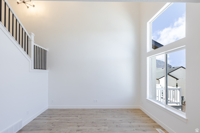 4752 Heartwood Road, Unit 433 Mapleton, UT 84664 - Photo 9 of 20 Empty room featuring a high ceiling and light wood-style flooring