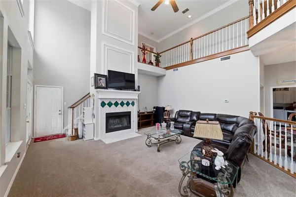 a living room with furniture a fireplace and a flat screen tv