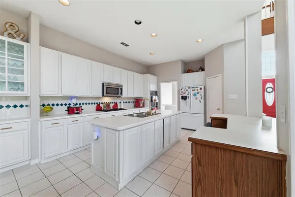 a kitchen with white cabinets a sink and white appliances