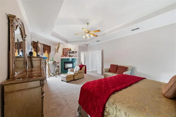 a bedroom with bed and two large mirror