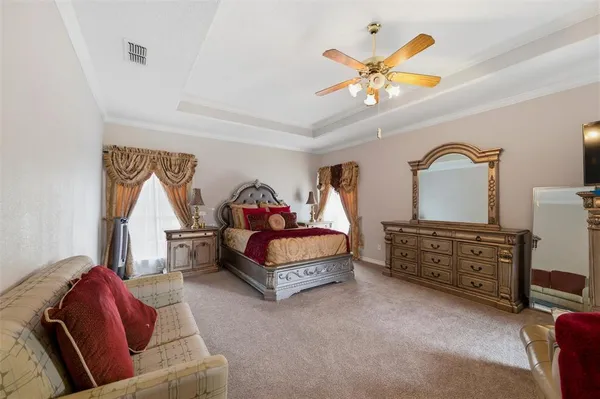 a living room with furniture and a ceiling fan