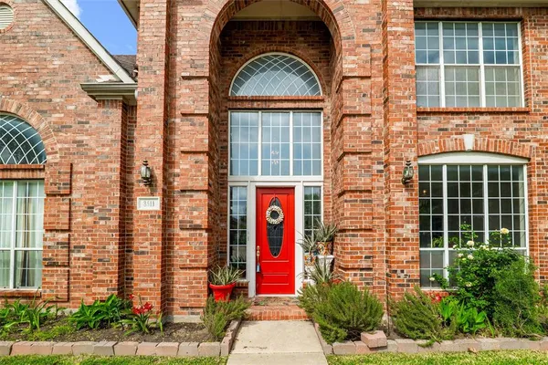 a view of front door of house and tree