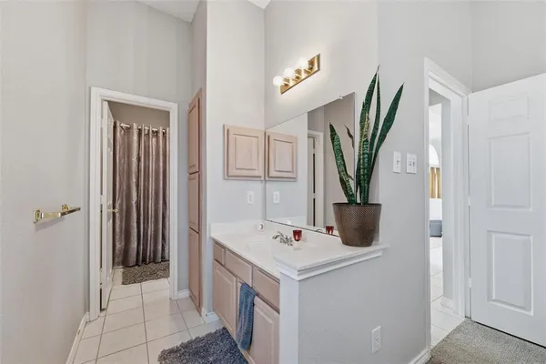 a view of bathroom with a sink and mirror