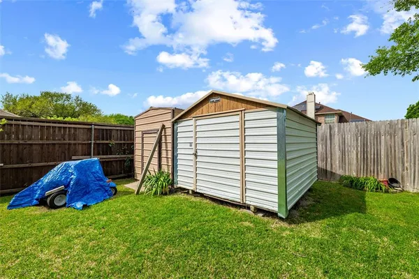 a view of a backyard with a garden and entertaining space
