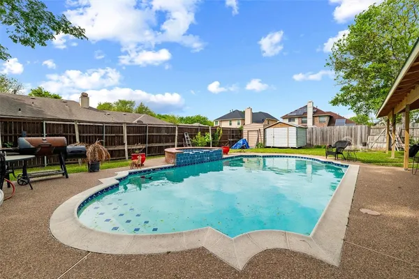 an aerial view of a house with swimming pool and porch