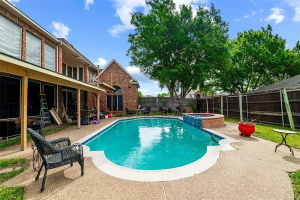 a view of a house with swimming pool and porch