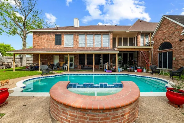 front view of a house with swimming pool garden and patio