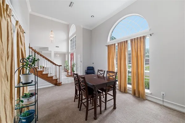 a dining room with furniture entryway and a window