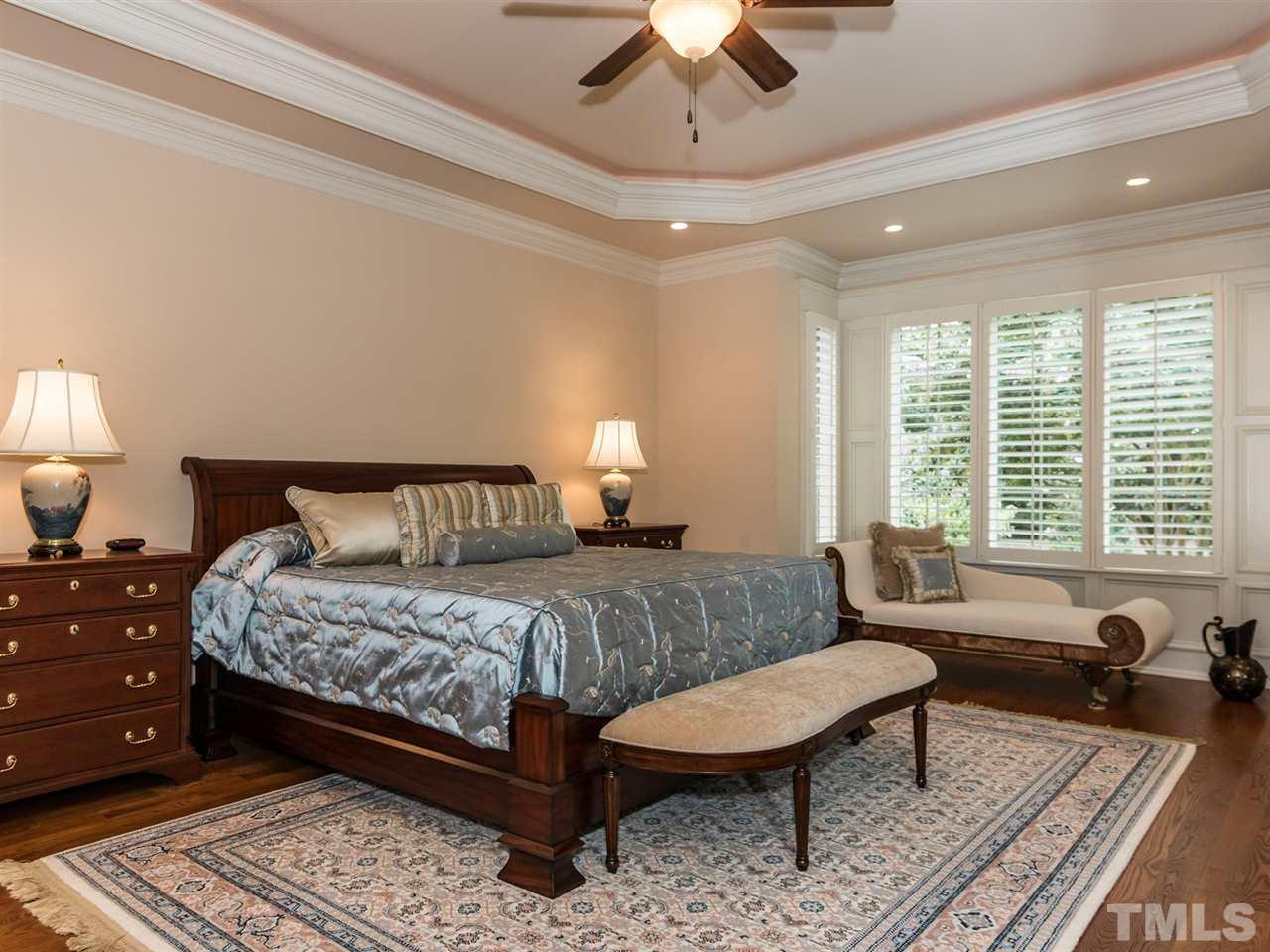 5216 Newstead Manor Lane Raleigh, NC 27606 - Photo 14 of 25 The spacious 1st floor master bedroom has a lighted trey ceiling, sitting area, crown molding and patio access.