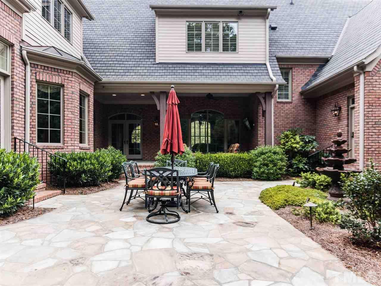 5216 Newstead Manor Lane Raleigh, NC 27606 - Photo 22 of 25 The stone patio has a built-in natural gas fire pit as well as a designated hook-up for the gas grill. Spending time in this well-designed and landscaped space will be a joy. There is architectural lighting for night time enjoyment as well.