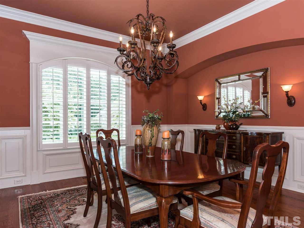 5216 Newstead Manor Lane Raleigh, NC 27606 - Photo 7 of 25 The formal dining room is very elegant and will be the perfect space for hosting holiday meals or family parties. Wainscoting, crown molding and the niche with lighting add charm.