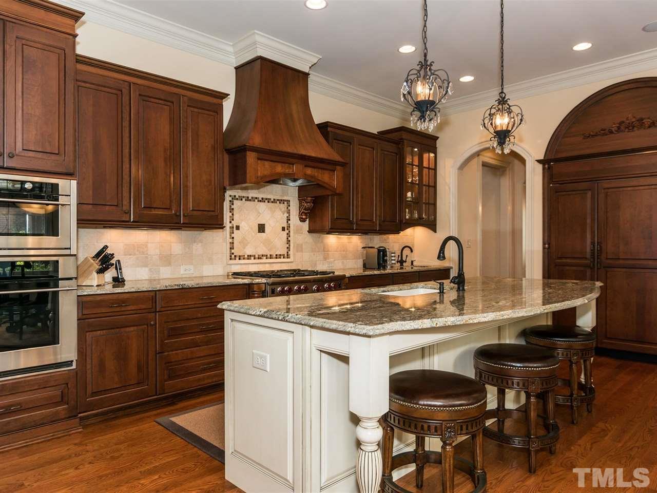5216 Newstead Manor Lane Raleigh, NC 27606 - Photo 9 of 25 Custom cherry cabinetry with the appearance of furniture is an ideal feature. This home has warmth and charm throughout.