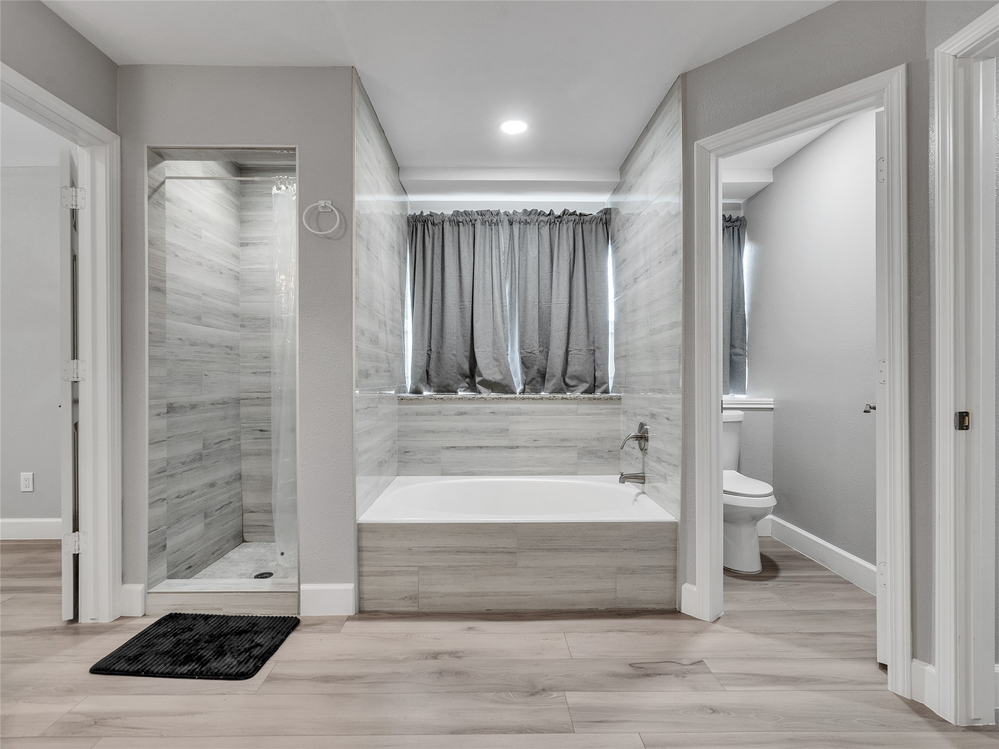 22302 Mosswillow Lane Tomball, TX 77375 - Photo 12 of 23 Don't you just love the primary bath? Whether you need a shower or to just soak in the tub, you have the luxury of having this great choice! Even the commode has its own private escape!