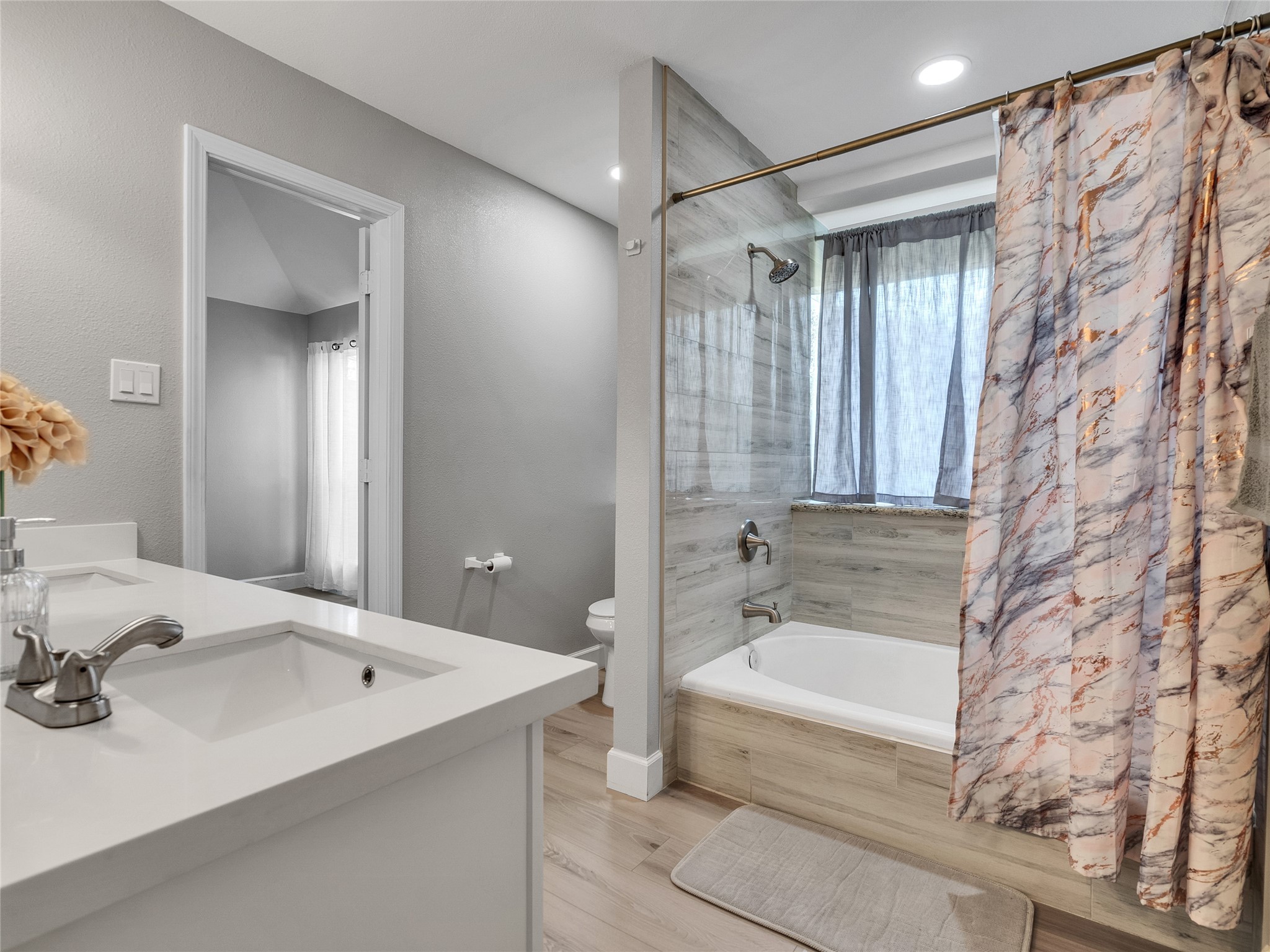 22302 Mosswillow Lane Tomball, TX 77375 - Photo 17 of 23 The second bath features a shower/tub combo with custom tile work.