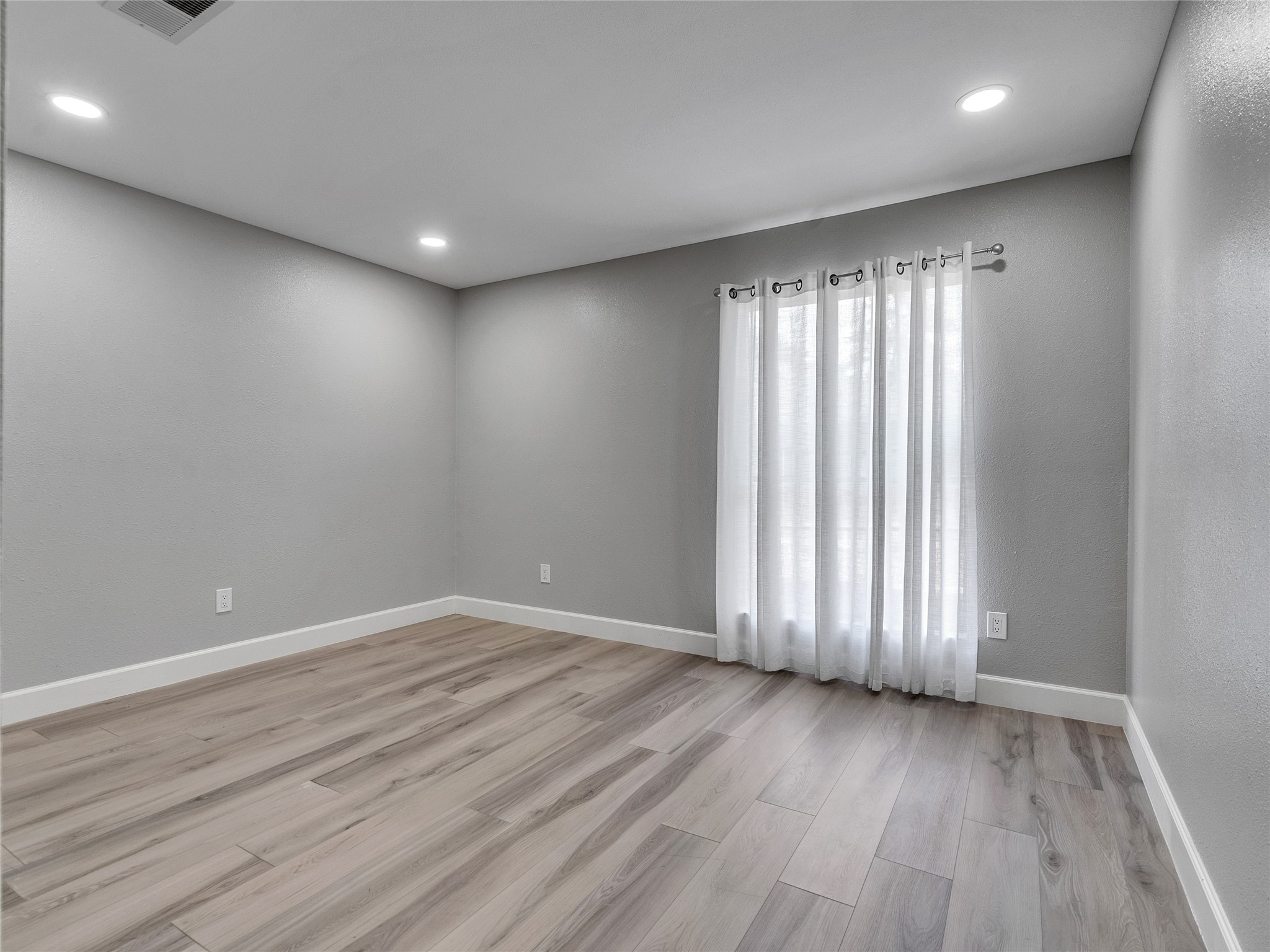 22302 Mosswillow Lane Tomball, TX 77375 - Photo 19 of 23 The large 3rd bedroom is at the rear of the house and allows plenty of space for furniture.