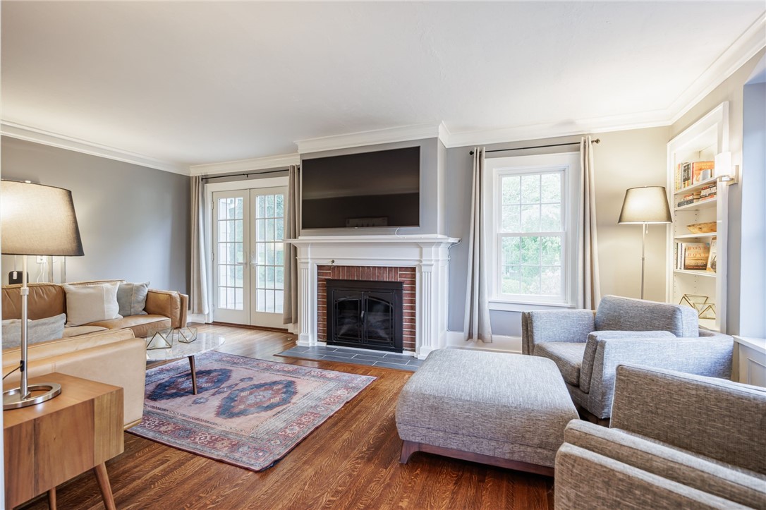 387 Kilbourn Road Rochester, NY 14618 - Photo 13 of 42 Gleaming hardwood floors and a brick fireplace define this comfortable living space.