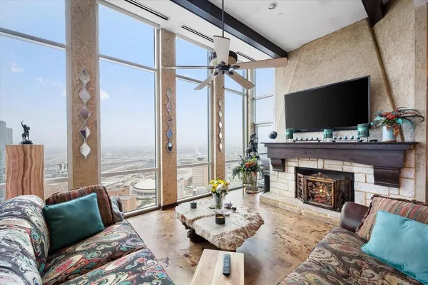 a living room with furniture a fireplace and a flat screen tv