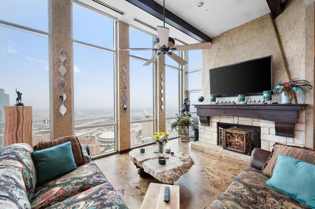 a living room with furniture a fireplace and a flat screen tv