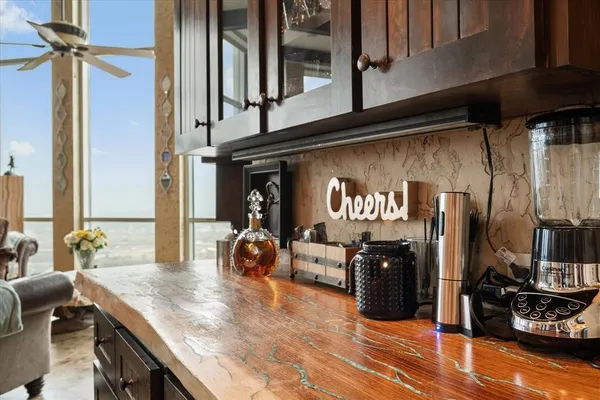 a kitchen with stainless steel appliances granite countertop a sink dishwasher stove and refrigerator with wooden floor
