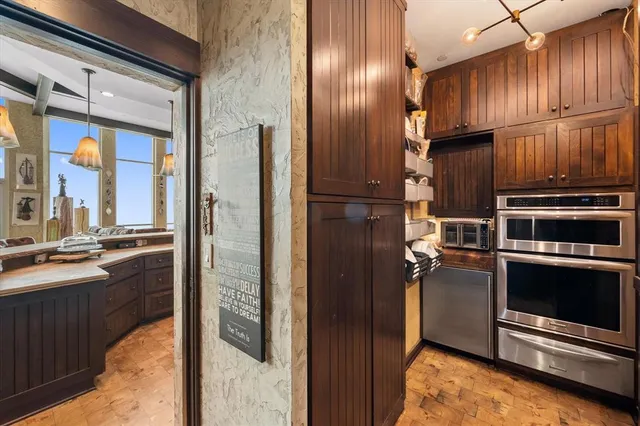 a kitchen with stainless steel appliances granite countertop a refrigerator a stove and a sink