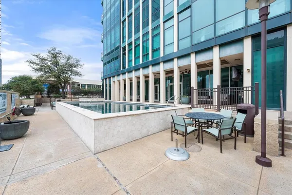 a view of a swimming pool with outdoor seating