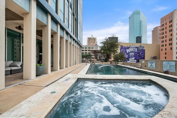 a building outdoor space with patio furniture and garden