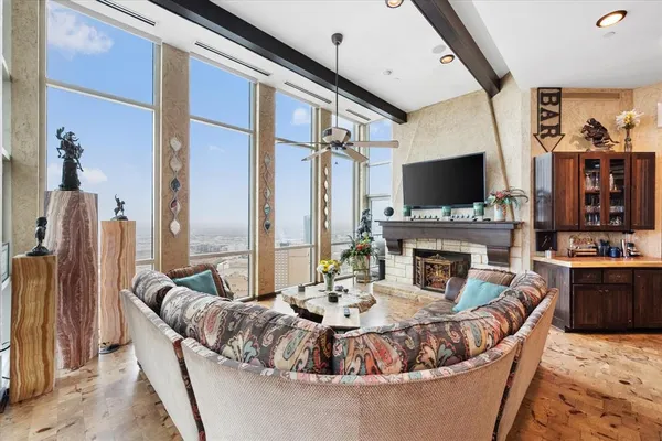 a living room with furniture a fireplace and a flat screen tv