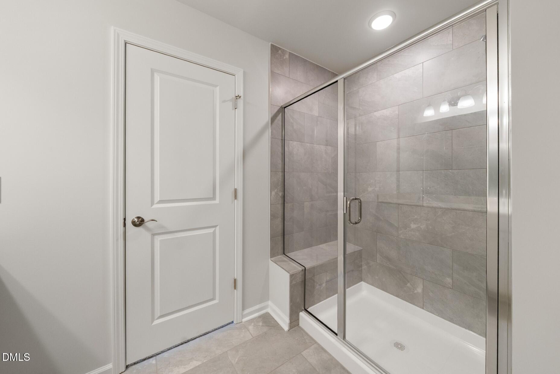 213 Bridle Brk Way Fuquay-Varina, NC 27526 - Photo 14 of 25 a bathroom with a glass shower door
