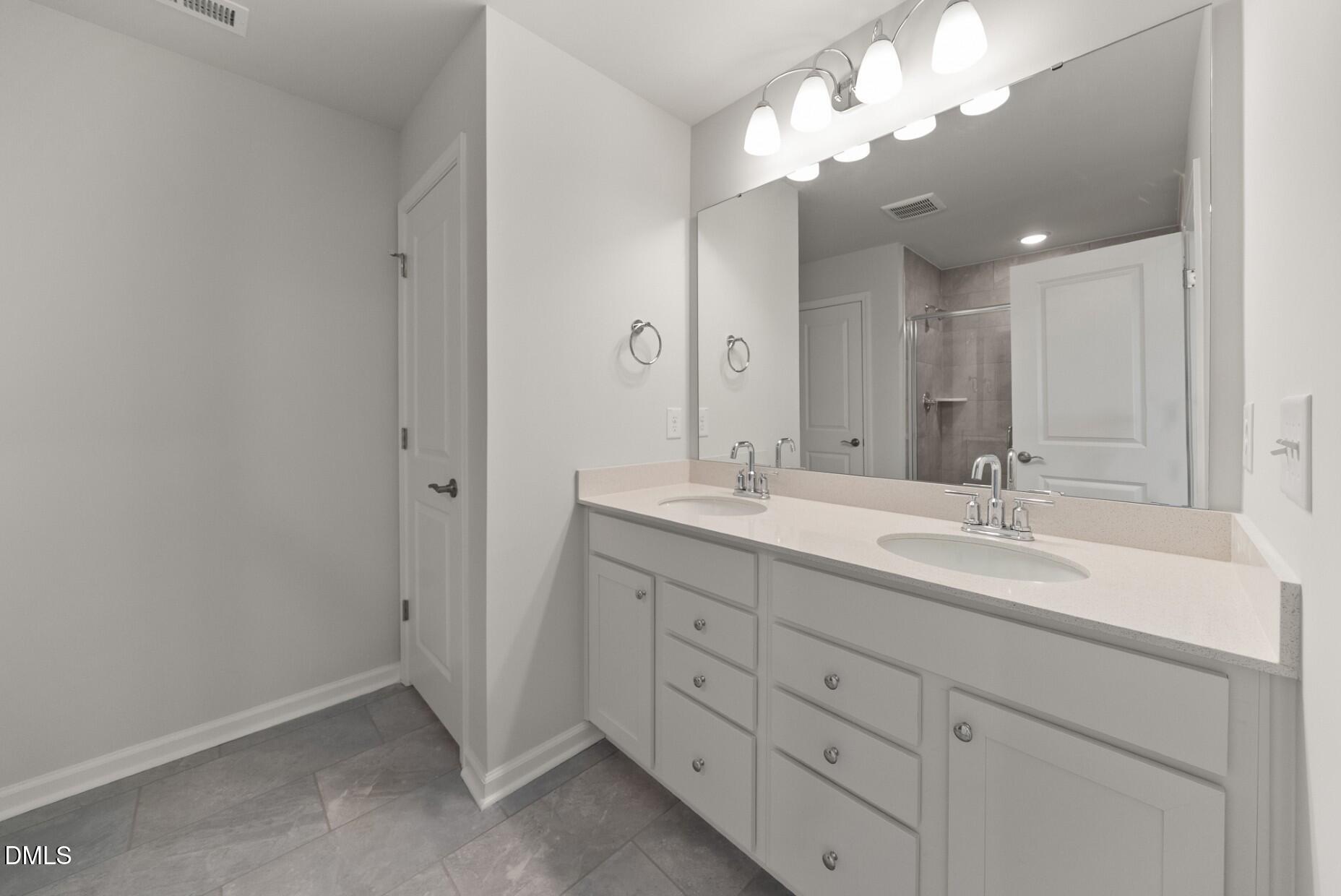 213 Bridle Brk Way Fuquay-Varina, NC 27526 - Photo 15 of 25 a bathroom with double sink a mirror and a light fixture