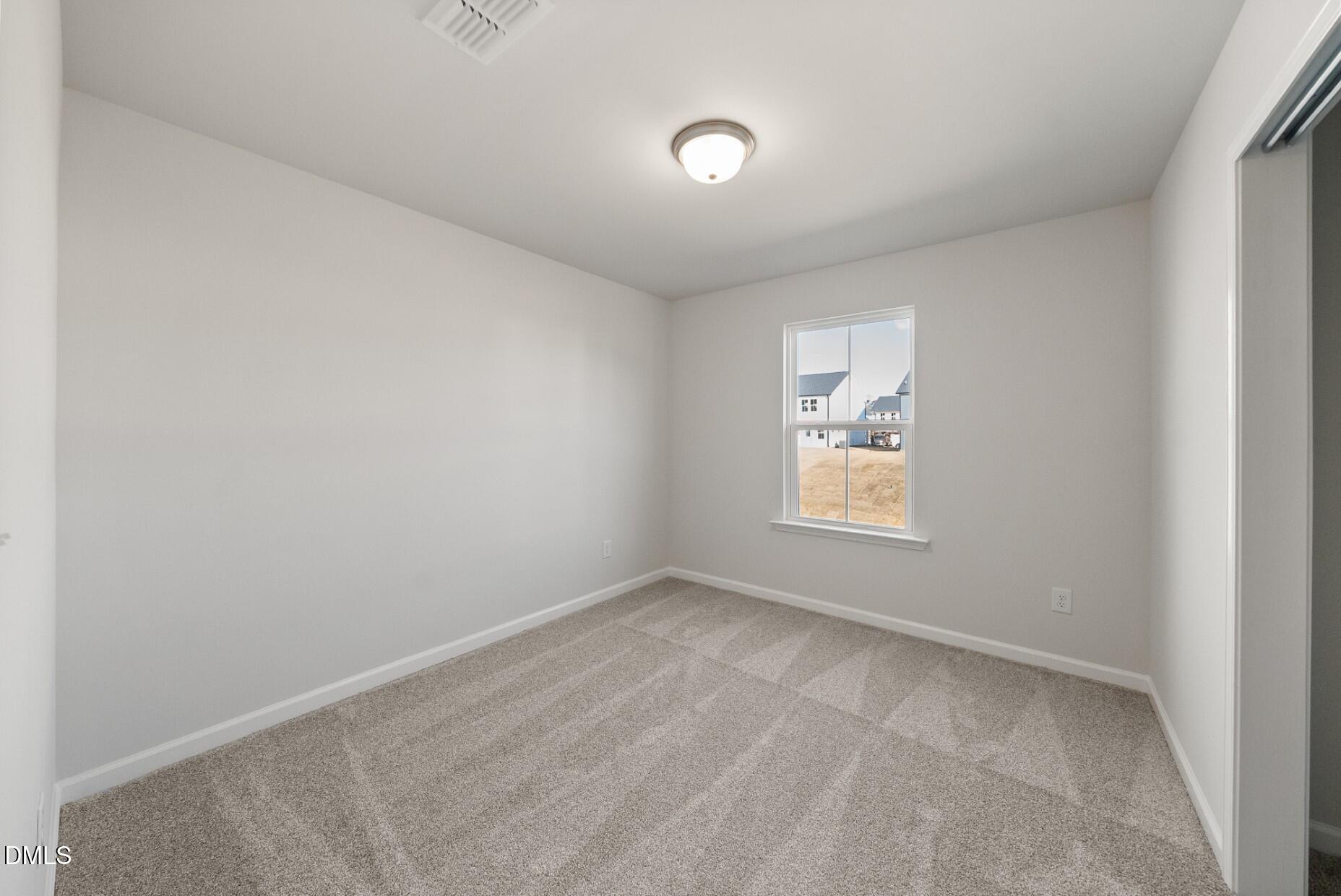 213 Bridle Brk Way Fuquay-Varina, NC 27526 - Photo 18 of 25 a view of an empty room with a window