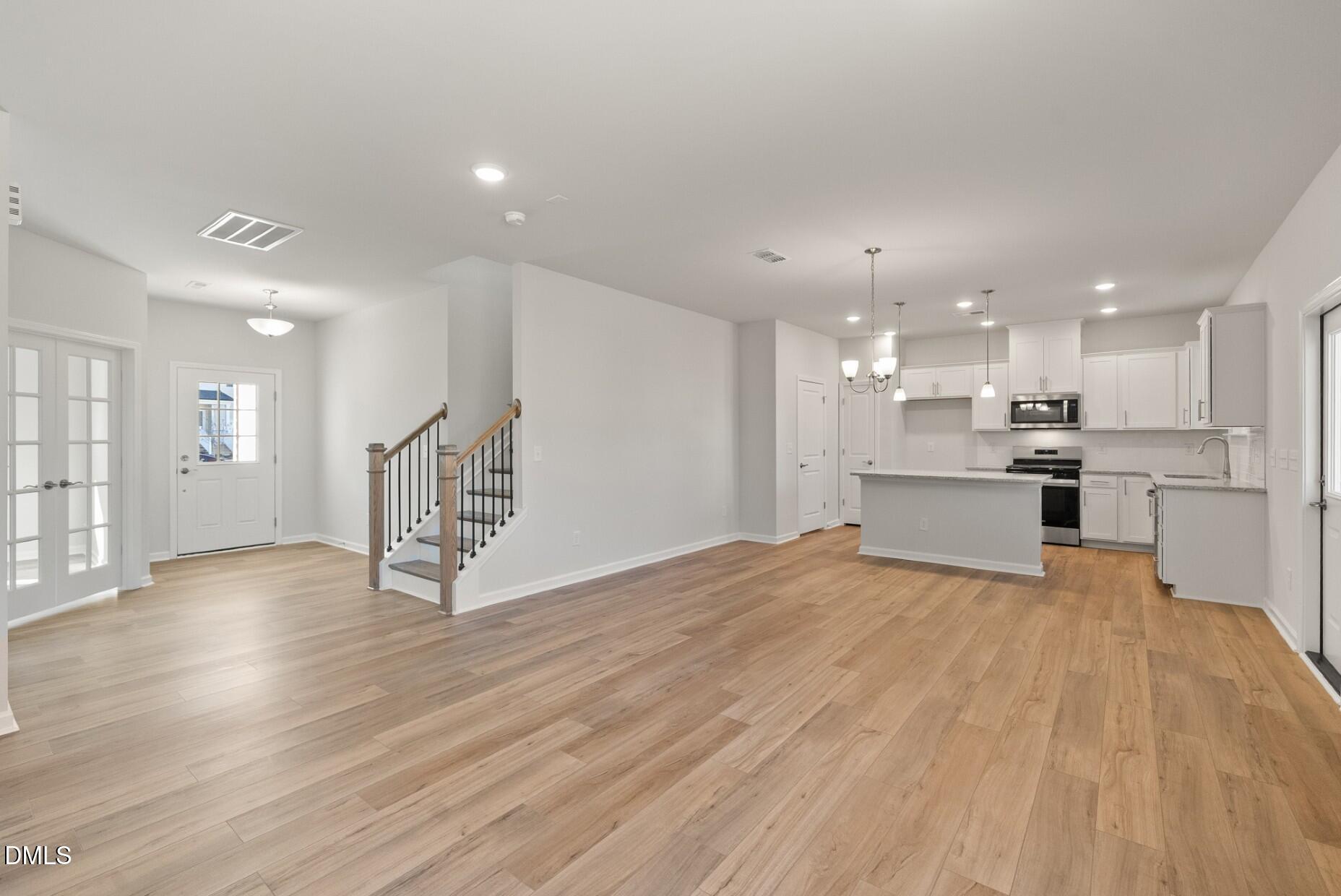 213 Bridle Brk Way Fuquay-Varina, NC 27526 - Photo 6 of 25 a view of kitchen with wooden floor and window