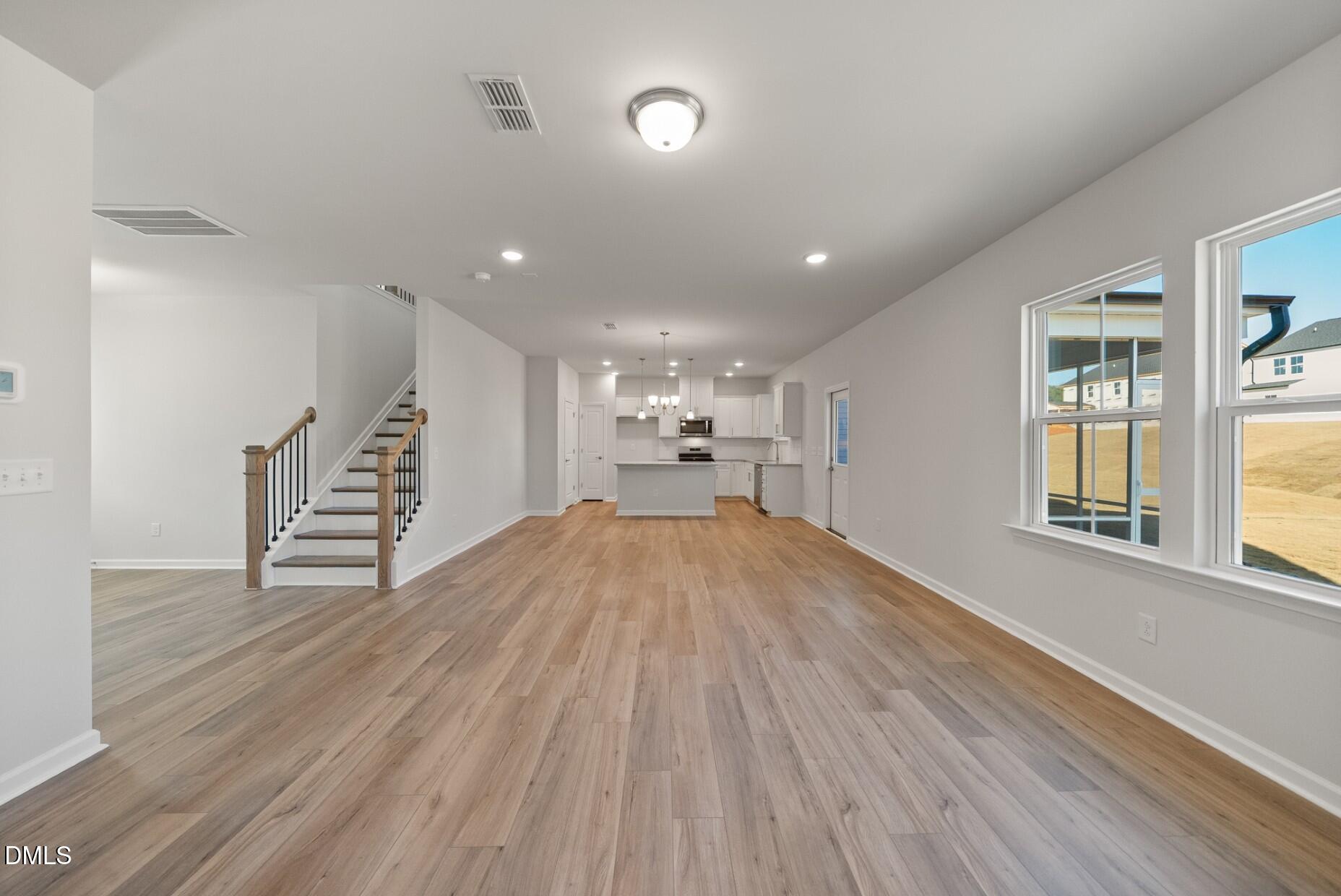 213 Bridle Brk Way Fuquay-Varina, NC 27526 - Photo 8 of 25 an empty room with wooden floor and windows