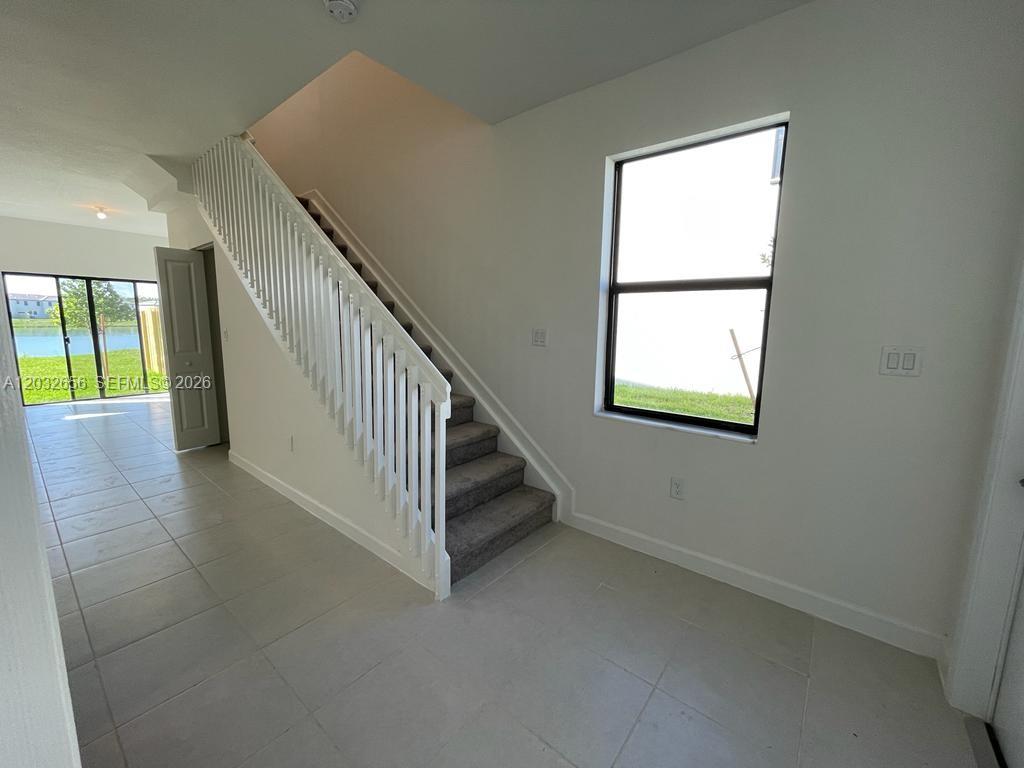 10144 Southwest 228th Terrace Miami, FL 33190 - Photo 4 of 23 an entryway in a hall with a window