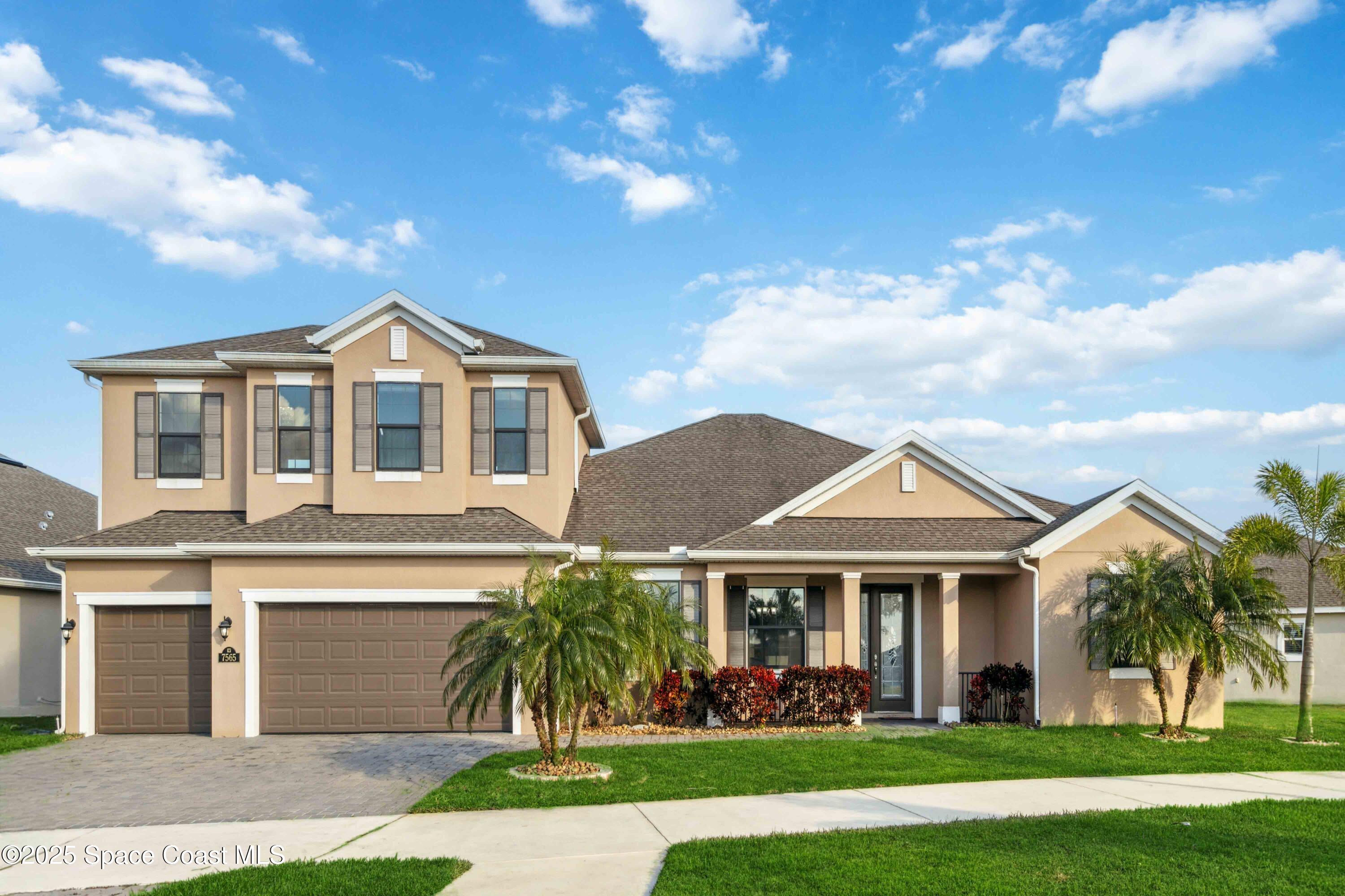 7565 Millbrook Avenue Melbourne, FL 32940 - Photo 1 of 47 a front view of a house with a garden and plants