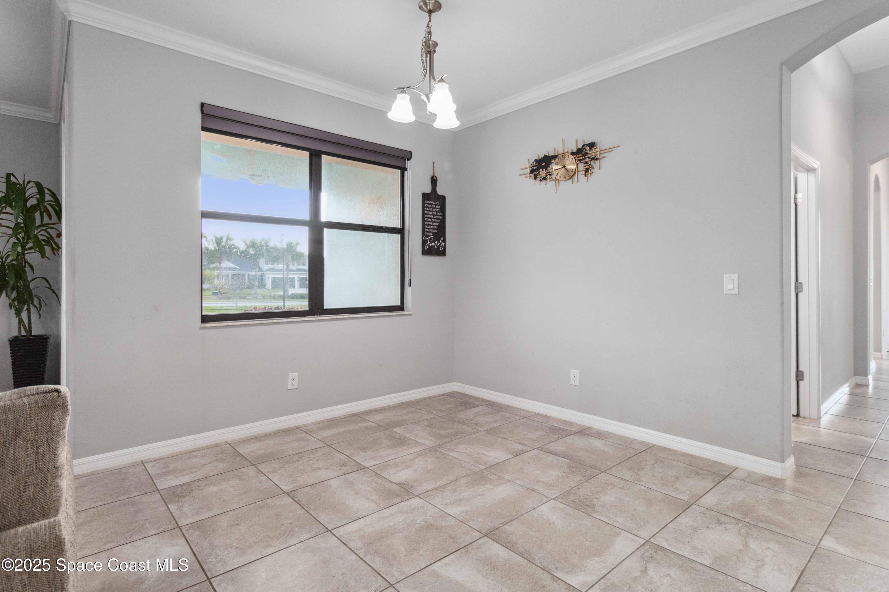 7565 Millbrook Avenue Melbourne, FL 32940 - Photo 13 of 47 an empty room with windows and entrance