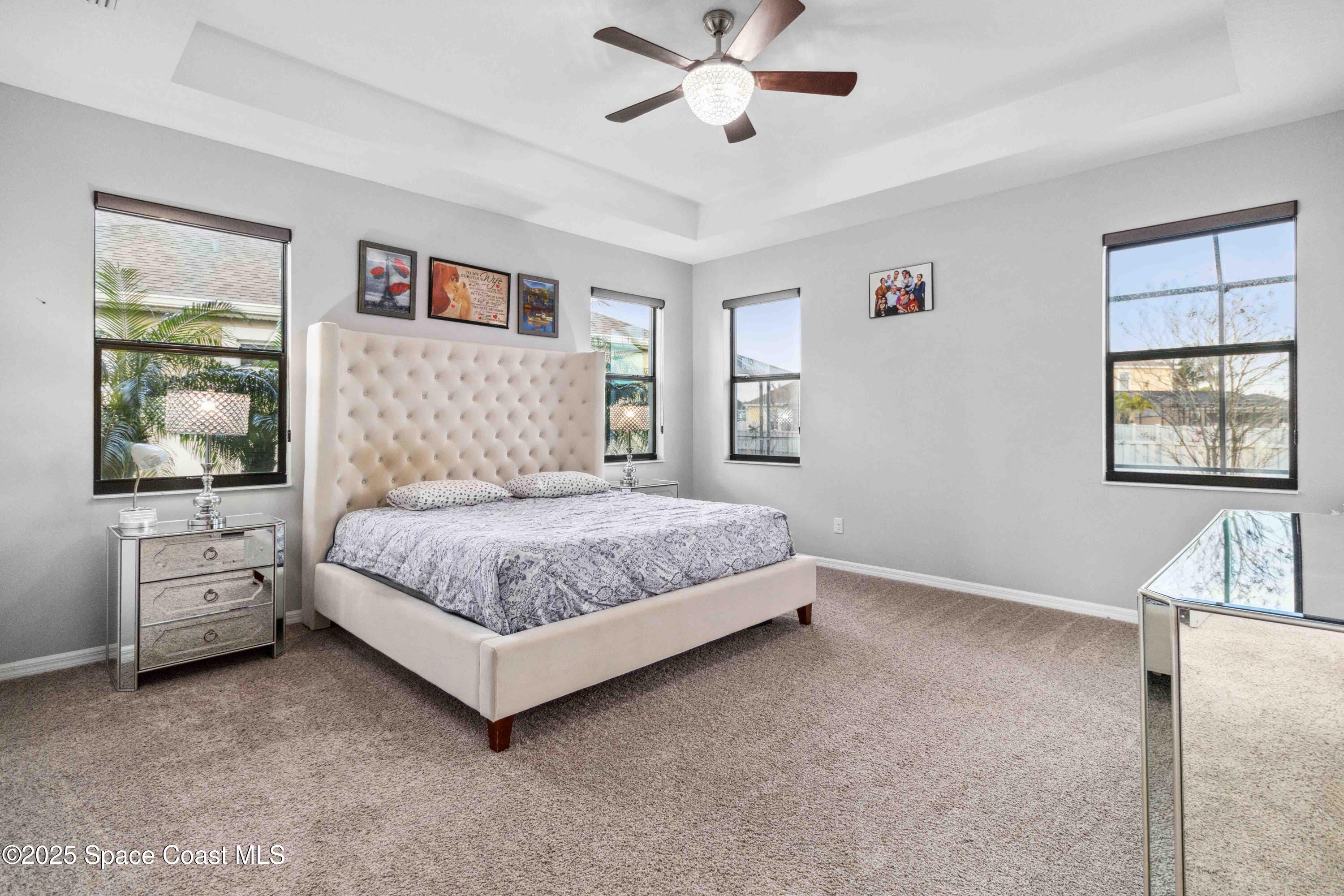 7565 Millbrook Avenue Melbourne, FL 32940 - Photo 14 of 47 a bedroom with a large bed and windows