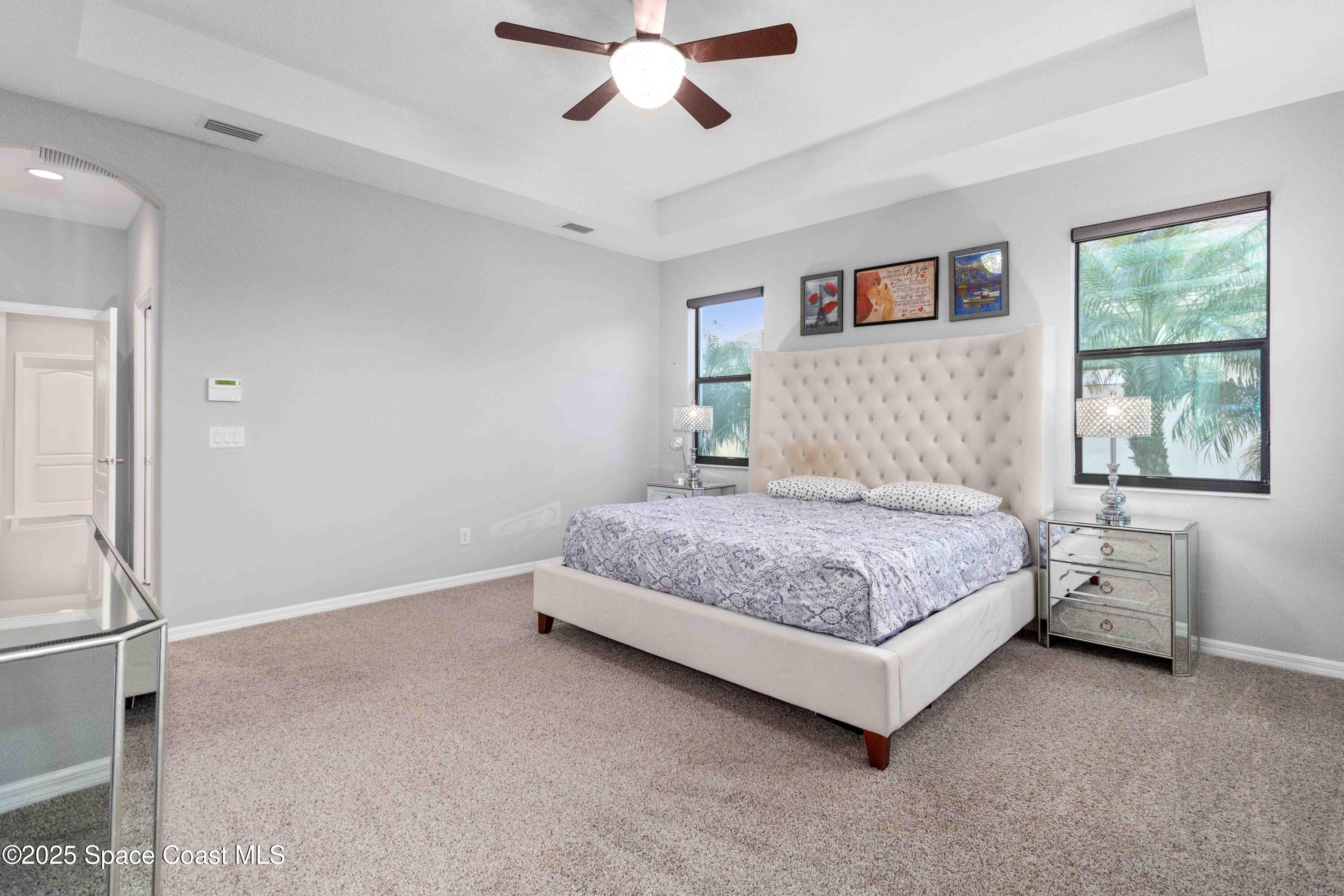7565 Millbrook Avenue Melbourne, FL 32940 - Photo 15 of 47 a bedroom with a bed and window