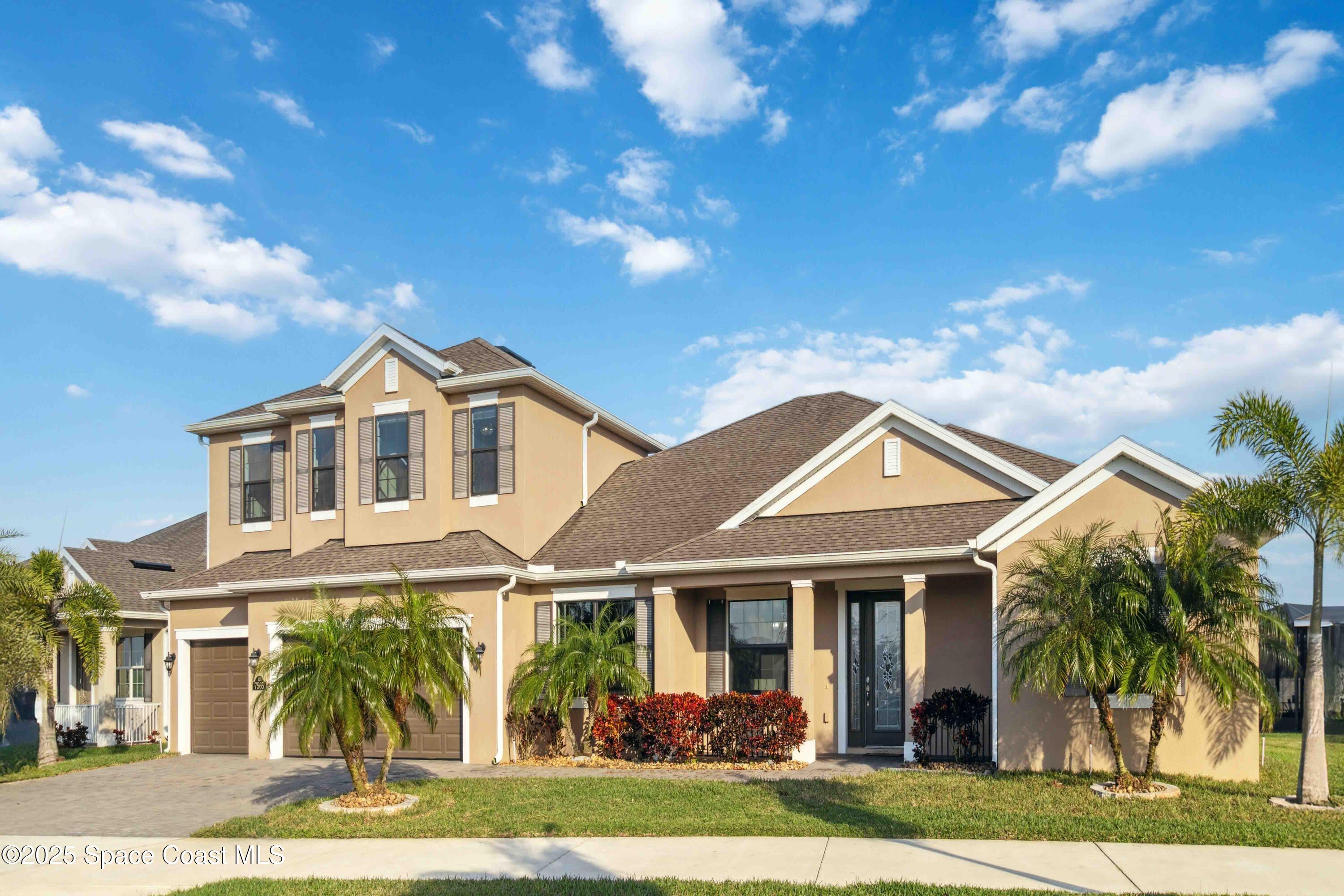 7565 Millbrook Avenue Melbourne, FL 32940 - Photo 2 of 47 a front view of a house with garden