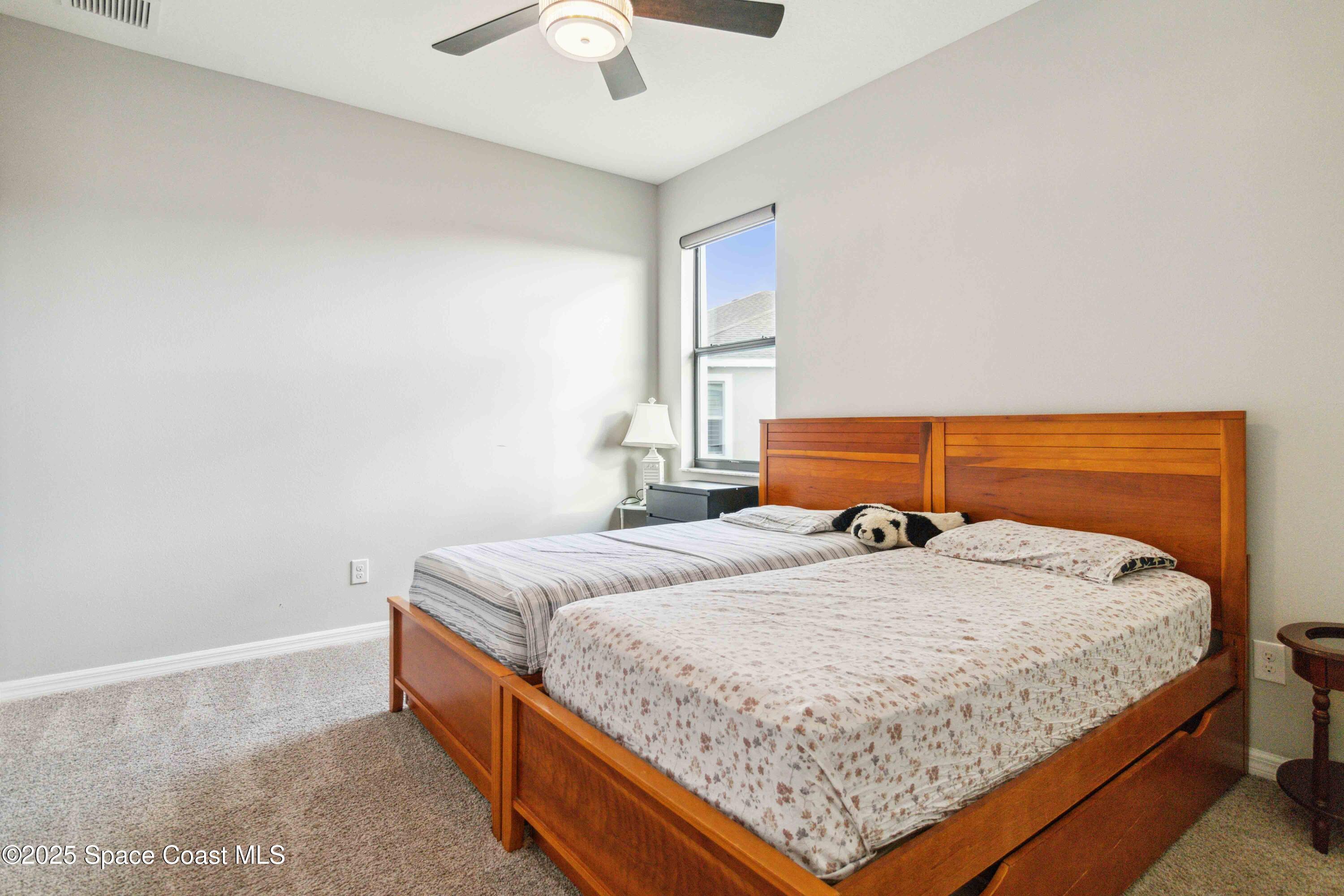 7565 Millbrook Avenue Melbourne, FL 32940 - Photo 21 of 47 a bedroom with bed and window