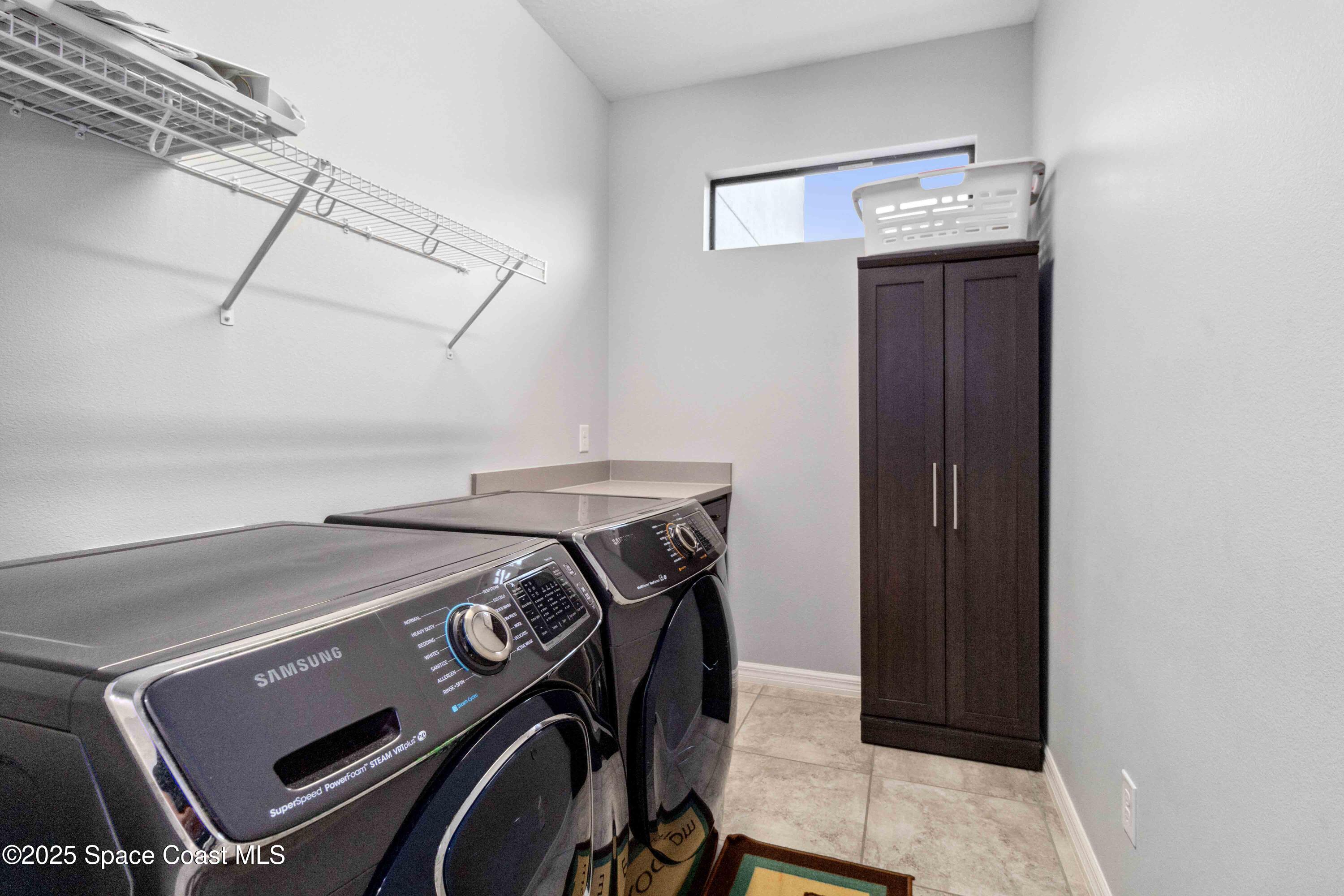 7565 Millbrook Avenue Melbourne, FL 32940 - Photo 24 of 47 a utility room with dryer and washer