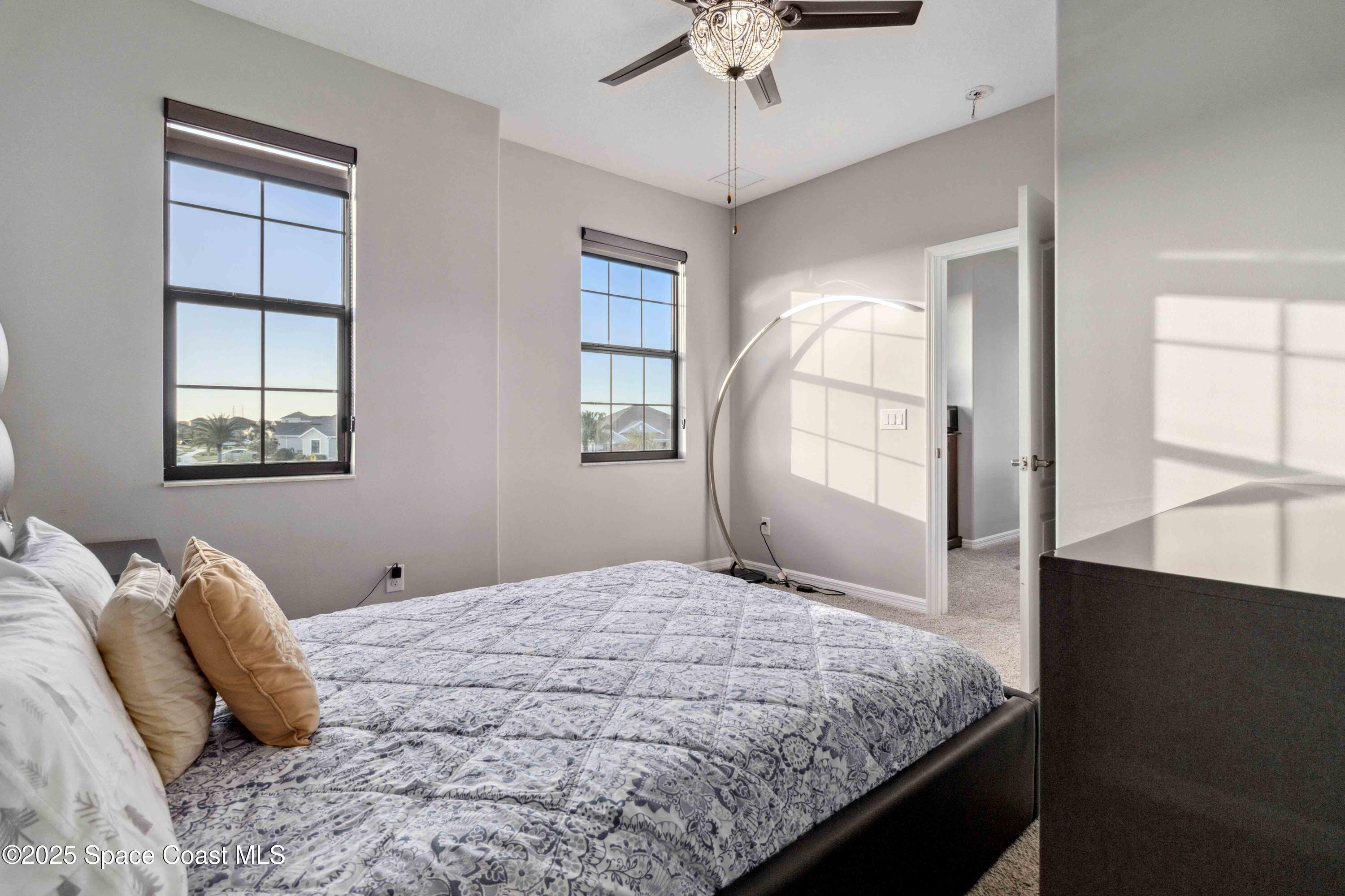 7565 Millbrook Avenue Melbourne, FL 32940 - Photo 28 of 47 a bedroom with a large bed and a window